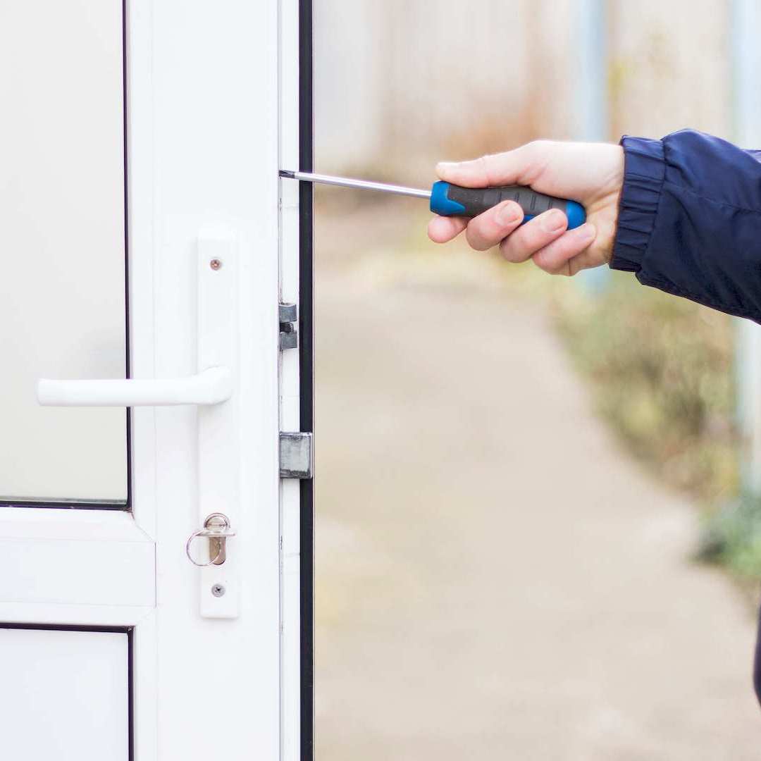 Egy ajtószerelő műanyag ajtó beállítása közben Őrbottyánen