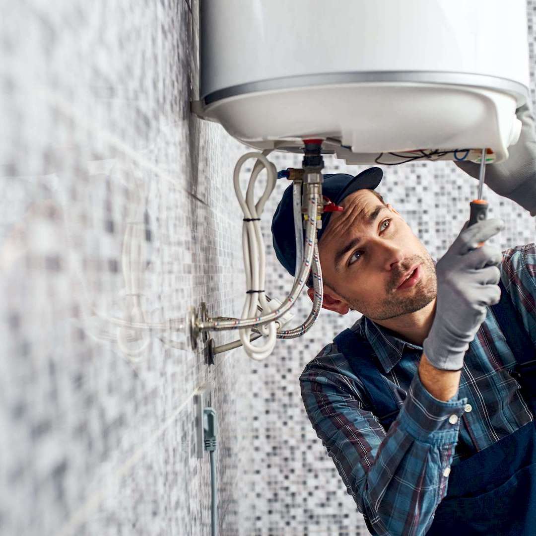 Egy vízszerelő ecofix bojler hőfokszabályzó beállítás közben Nyíregyházán